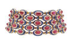 Choker in gold with rubies, sapphires, lapis lazuli and diamonds, ca 1979. Designed as three rows, each of ten oval elements each set at the centre with a cabochon ruby in a surround of brilliant-cut diamonds and lapis lazuli spaced by small cabochon sapphires. Marks: on the rim of the clasp, on one side: "BVLGARI" stamped; on the reverse of the clasp: numbered "1690".